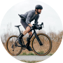 A young man wearing a helmet is riding a cyclocross bicycle